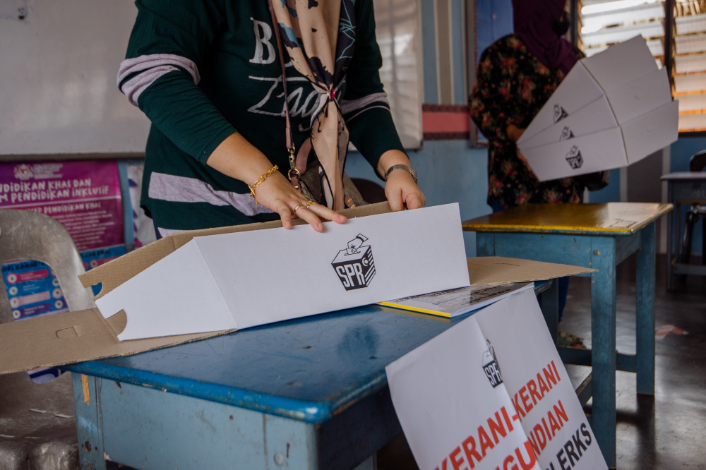 Election Commission staff prepare for polling day which will take place tomorrow at Sekolah Kebangsaan Asahan, Melaka, November 19, 2021. — Picture by Shafwan Zaidon
