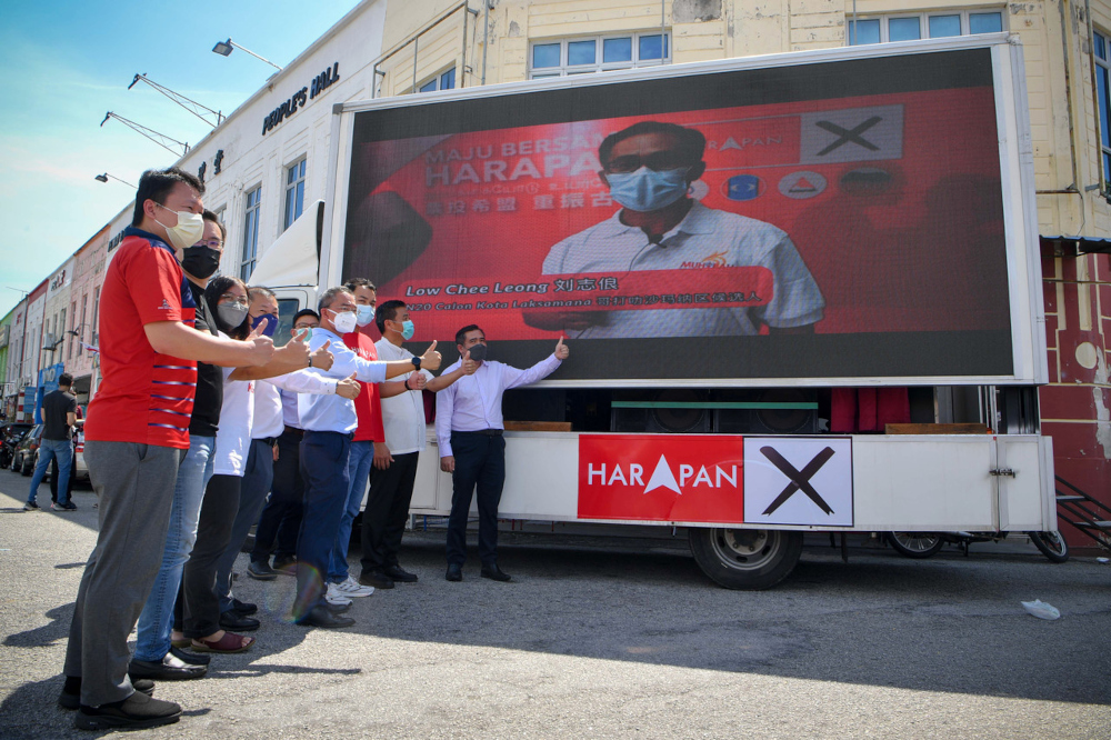 DAP national organising secretary Anthony Loke (right) with Pakatan Harapan candidates posing for a photo after the Harapan Truck Launch ceremony in conjunction with the Melaka election at the DAP headquarters in Melaka, November 9, 2021. — Bernama pic 