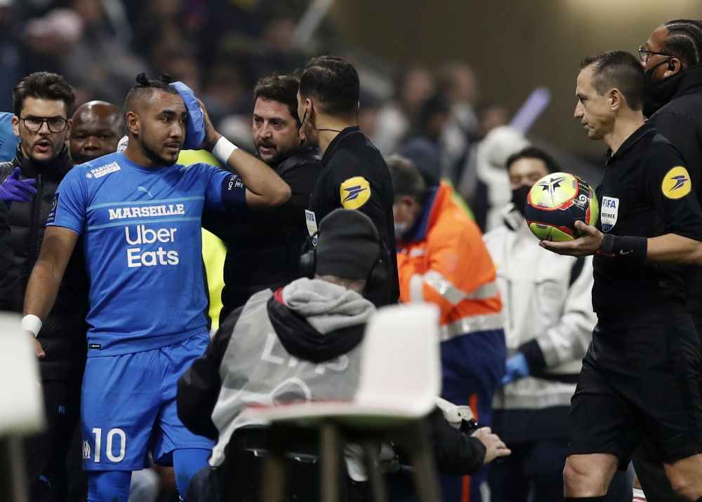 Olympique de Marseille's Dimitri Payet walks off the pitch injured after being hit by a water bottle thrown by a fan leading to the game being interrupted at the Groupama Stadium, Lyon November 21, 2021. u00e2u20acu201d Reuters pic