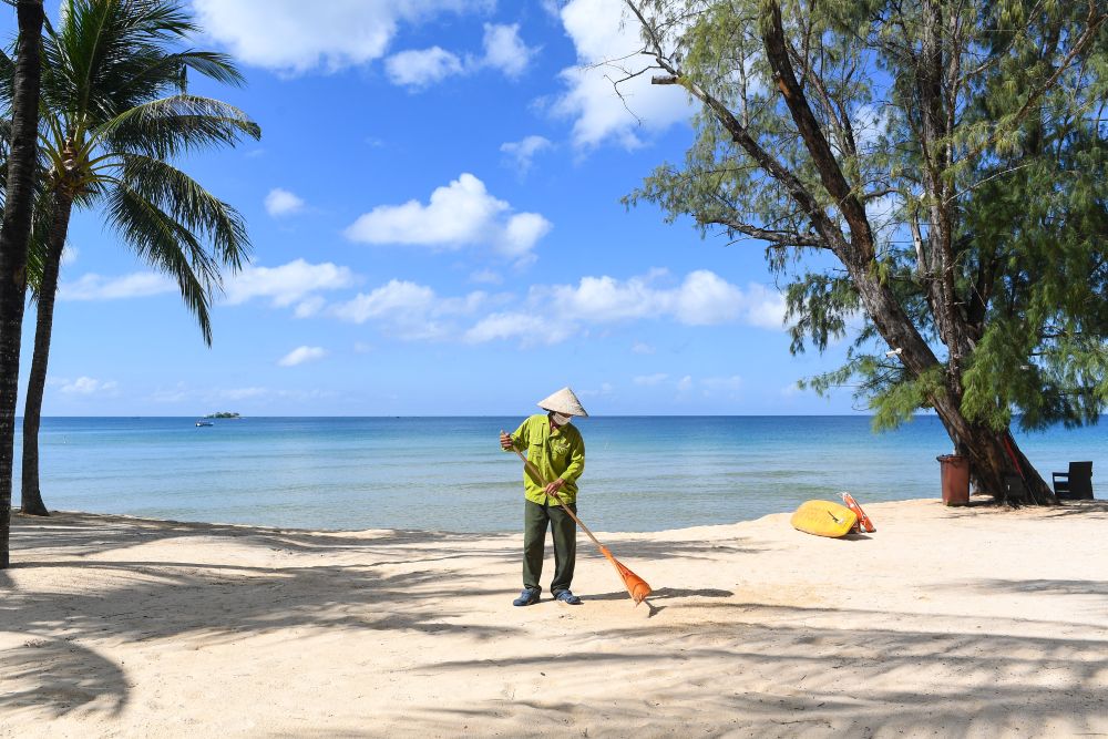 A staff member sweeps the grounds of the Vinpearl resort on Phu Quoc island on November 19, 2021. u00e2u20acu201d AFP pic