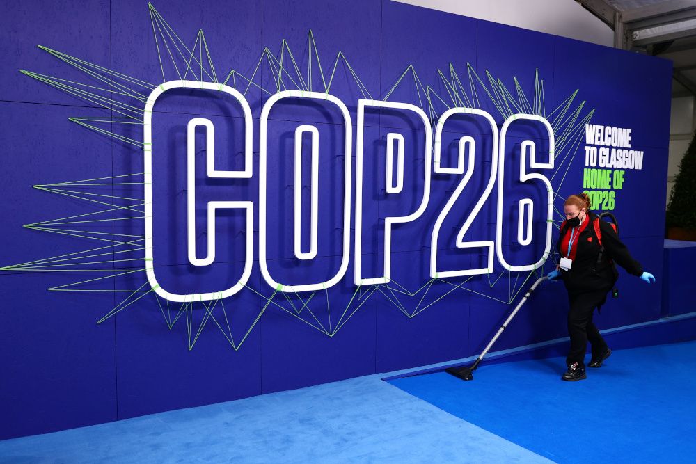 An employee cleans before the arrival of leaders for the UN Climate Change Conference (COP26) in Glasgow, Scotland November 1, 2021. u00e2u20acu201d Adrian Dennis/Pool pic via Reuters