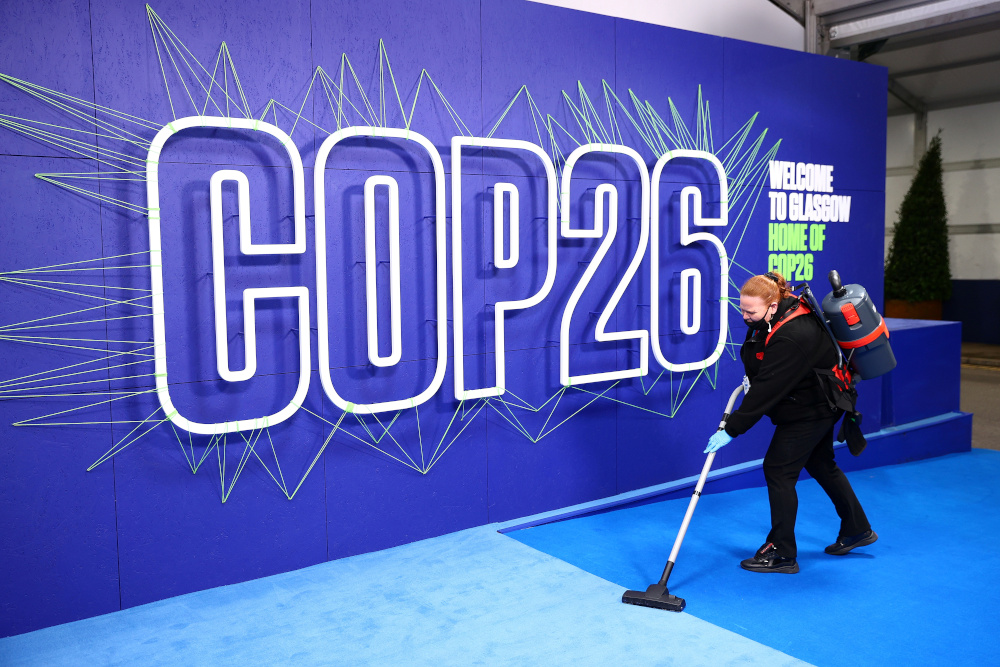 An employee cleans before the arrival of leaders for the UN Climate Change Conference (COP26) in Glasgow, Scotland November 1, 2021. u00e2u20acu201d Adrian Dennis/Pool pic via Reuters