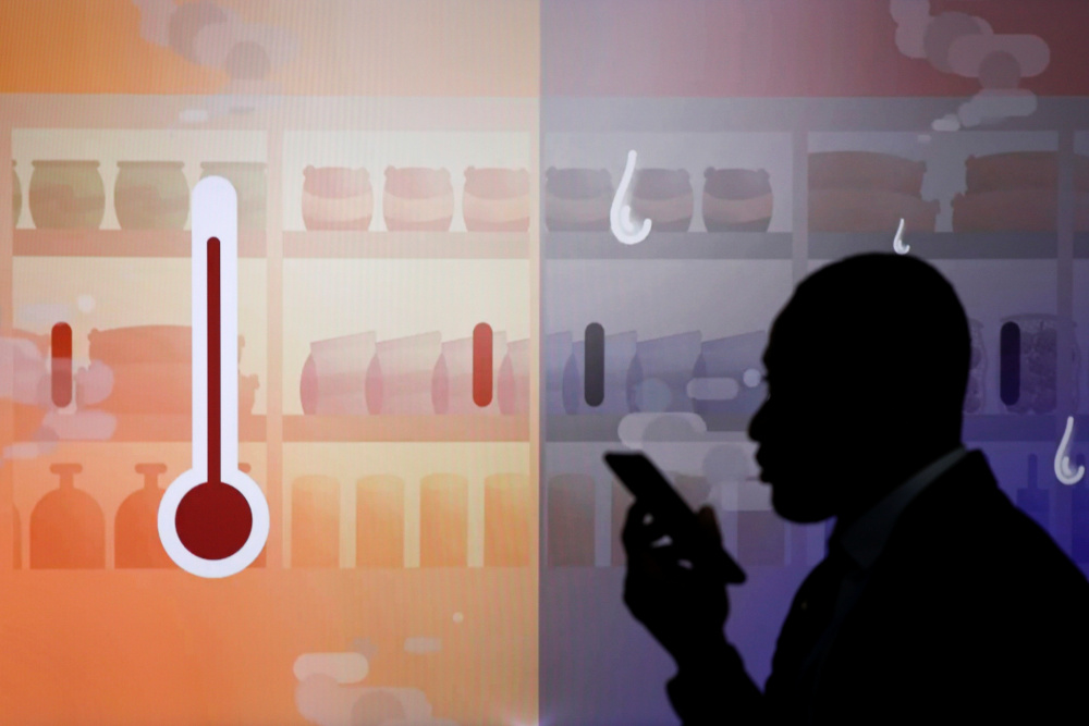 A person walks past a sign during the UN Climate Change Conference (COP26) in Glasgow November 2, 2021. u00e2u20acu201d Reuters pic