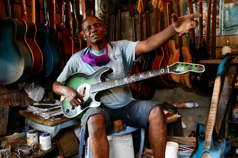 Guitar luthier Misoko Nzalayala Jean-Luther, alias Socklo, 61, gestures while he holds one of his instruments at his workshop in Kinshasa, Democratic Republic of Congo, October 18, 2021. u00e2u20acu201d Reuters pic
