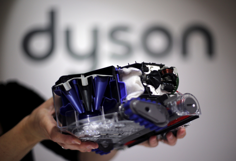 A Dyson employee shows a Dyson 360 Eye robot vacuum cleaner without its cover during the IFA Electronics show in Berlin September 4, 2014. u00e2u20acu201d Reuters pic