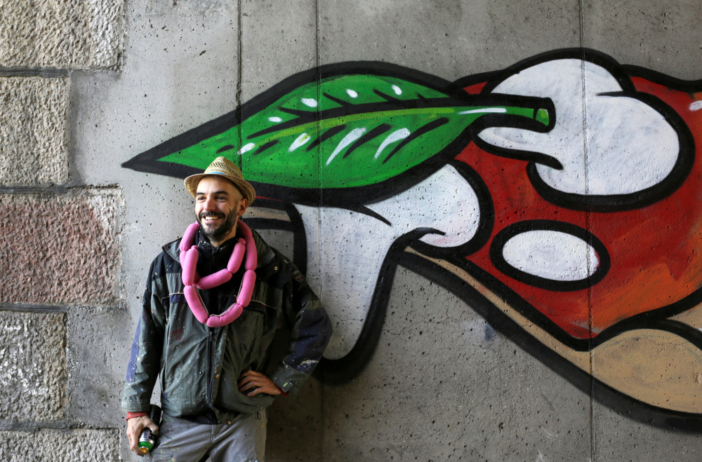 Italian street artist Pier Paolo Spinazze, 39, known as ‘Cibo’ (Italian for food), who covers racist graffiti with murals of food, poses for a portrait near Verona November 18, 2021. — Reuters pic