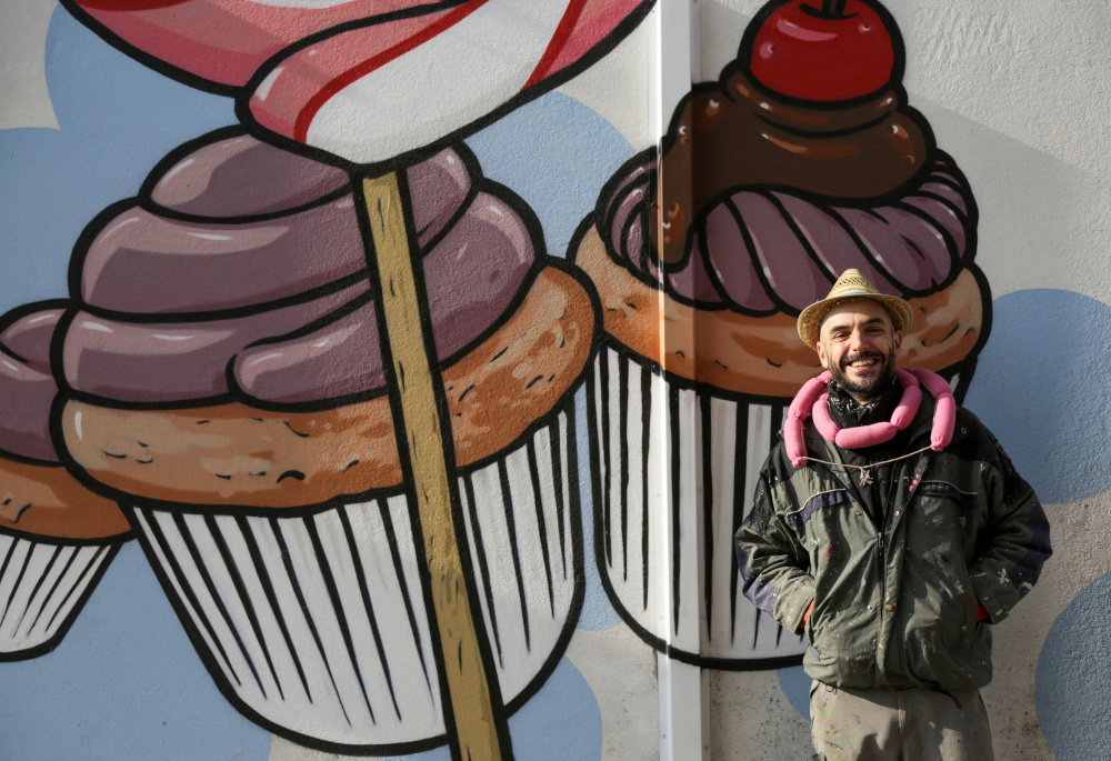 Italian street artist Pier Paolo Spinazze, 39, known as u00e2u20acu02dcCibou00e2u20acu2122 (Italian for food), who covers racist graffiti with murals of food, poses for a portrait near Verona November 18, 2021. u00e2u20acu201d Reuters pic