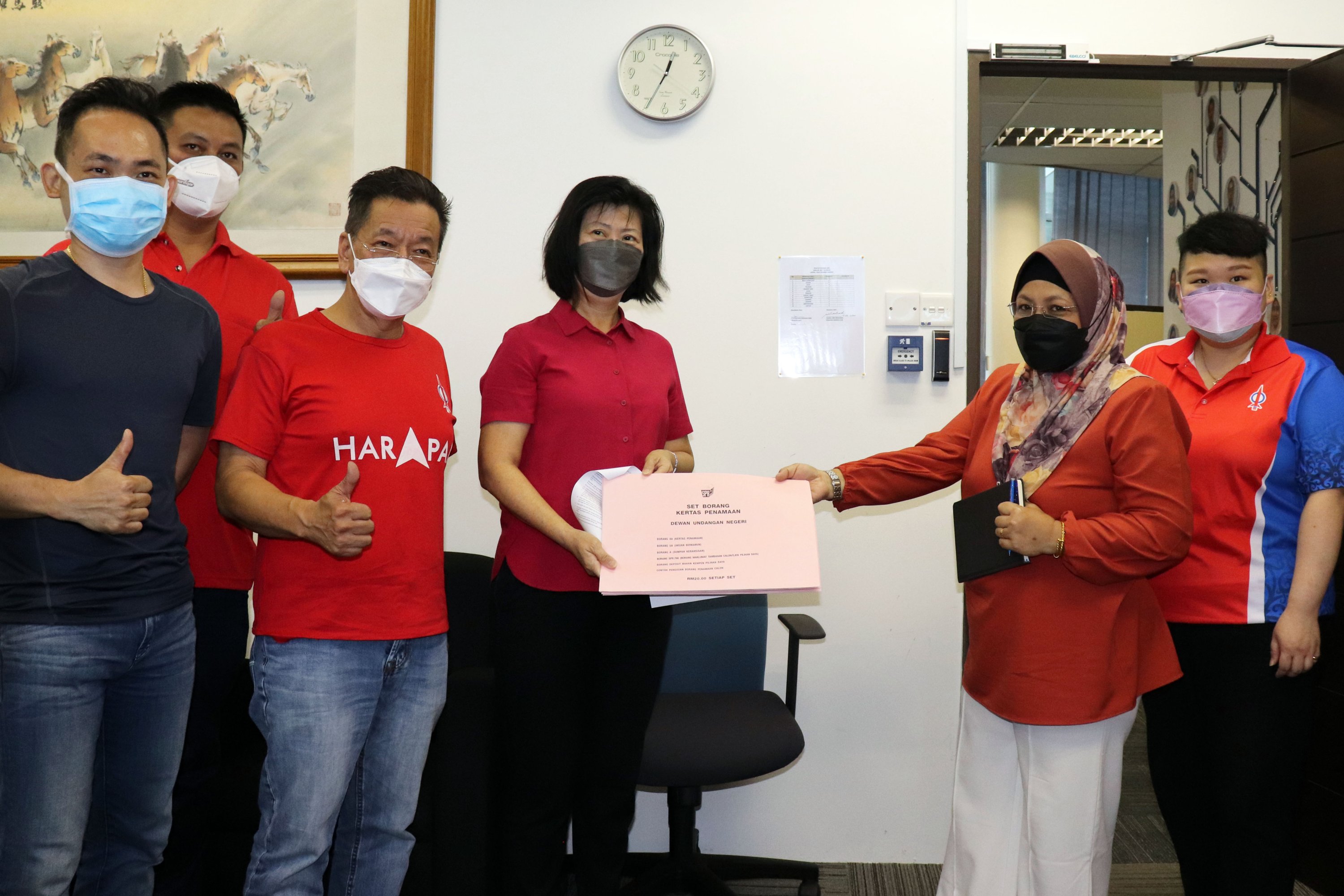 Chang (third, right) receives the nomination forms from Salehah, as (front, from left) Ling, Wong and Lau look on. u00e2u20acu201d Picture by Conny Banji via Borneo Post