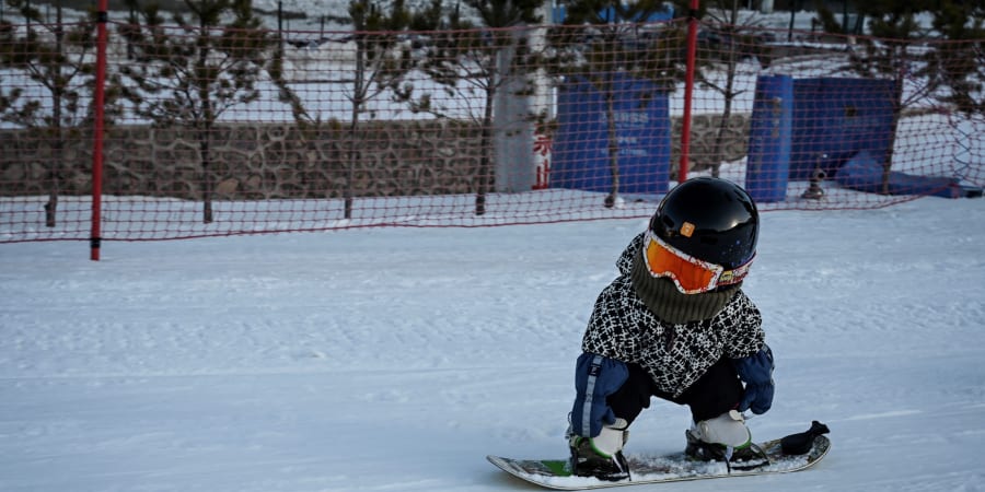 11-month-old toddler Wang Yuji sliding down a slope on her snowboard at a ski resort in Zhangjiakou, in northern China's Hebei province. u00e2u20acu201d ETX-Studio picnnn