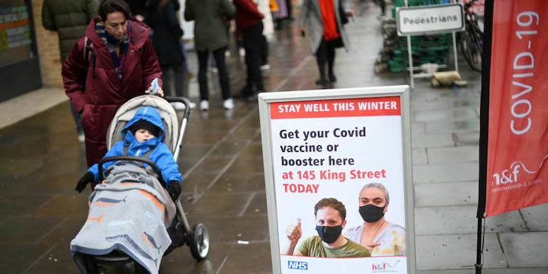 A woman walks past signage outside a pop-up vaccination centre for the Covid-19 vaccine or booster, in Hammersmith and Fulham in Greater London December 3, 2021. u00e2u20acu201d AFP pic