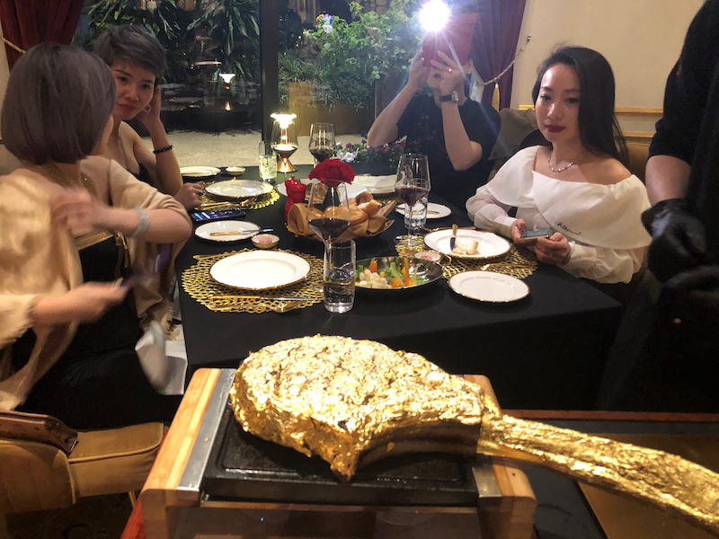 A customer takes pictures of a gold leaf-coated steak at a Dolce By Wyndham Hanoi Golden Lake hotel, in Hanoi, Vietnam December 7, 2021. u00e2u20acu201d Reuters pic