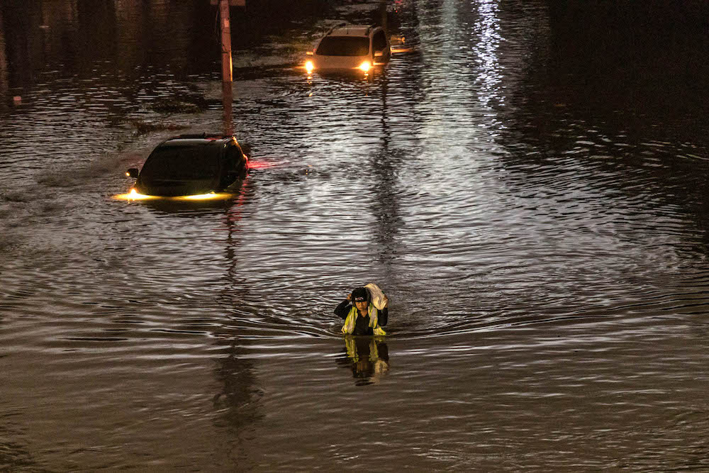 People wade through floodwaters at Jalan Sultan Azlan Shah in Kuala Lumpur amid incessant rain December 19, 2021. — Picture by Firdaus Latif