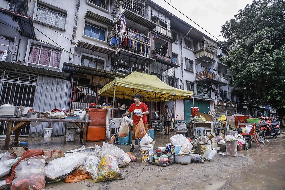 Residents in the Chow Kit area clean up after floods hit Kuala Lumpur December 19, 2021. u00e2u20acu201d Picture by Hari Anggara