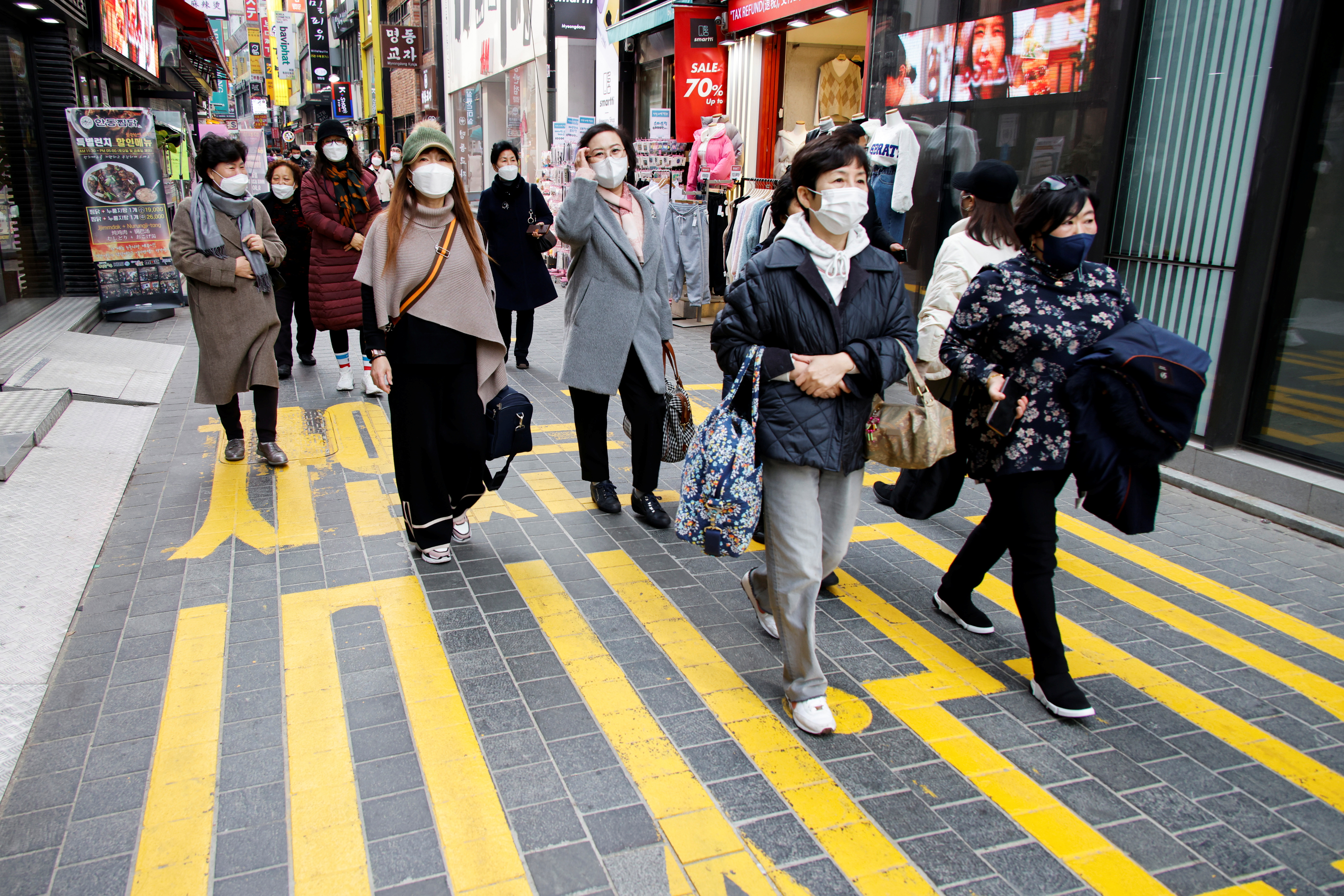 Women wearing masks walk in a shopping district amid the coronavirus disease pandemic in Seoul November 29, 2021. u00e2u20acu201d Reuters pic