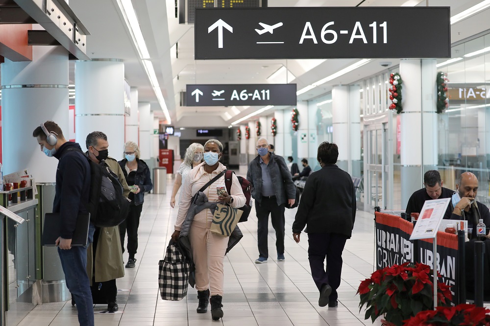 United States-bound passengers walk in Toronto Pearson Airportu00e2u20acu2122s Terminal 3, days before new coronavirus disease testing protocols to enter the US come into effect, in Toronto, Ontario December 3, 2021. u00e2u20acu201d Reuters pic