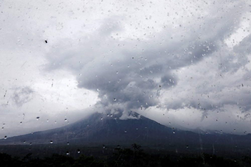 Mount Semeru volcano is seen through glass from the Volcano Observatory in Candipuro district following its eruption, Lumajang regency December 6, 2021. u00e2u20acu201d Reuters pic