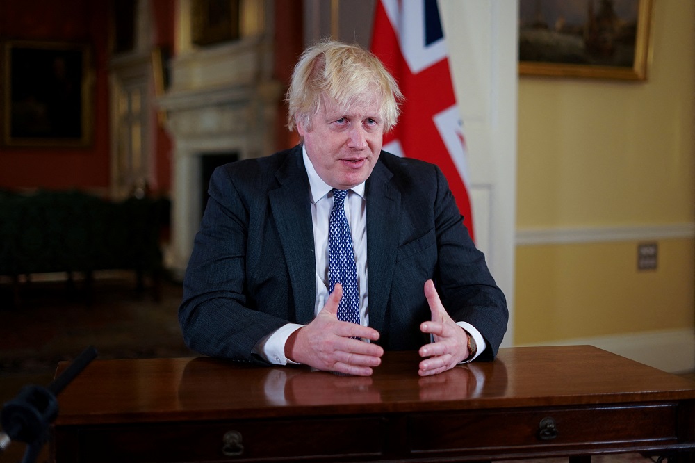 British Prime Minister Boris Johnson, gestures as he records an address to the nation, to provide an update on the booster vaccine COVID-19 programme at Downing Street, London December 12, 2021. u00e2u20acu201d Picture by Kirsty O'Connor/Pool via Reuters