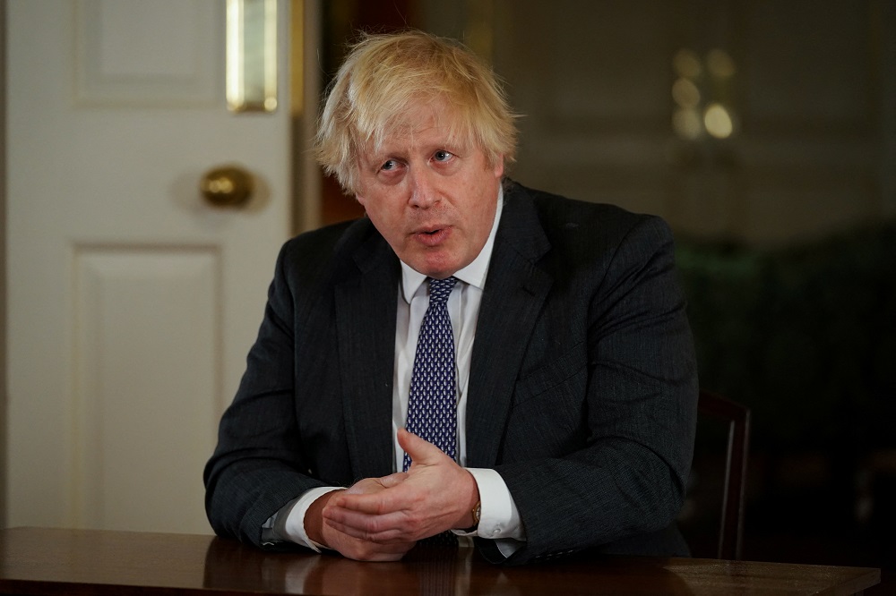 British Prime Minister Boris Johnson, gestures as he records an address to the nation, to provide an update on the booster vaccine COVID-19 programme at Downing Street, London December 12, 2021. u00e2u20acu201d Picture by Kirsty O'Connor/Pool via Reuters