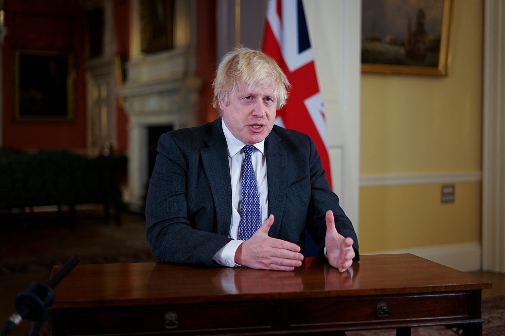 British Prime Minister Boris Johnson, gestures as he records an address to the nation, to provide an update on the booster vaccine COVID-19 programme at Downing Street, London December 12, 2021. u00e2u20acu201d Picture by Kirsty O'Connor/Pool via Reuters