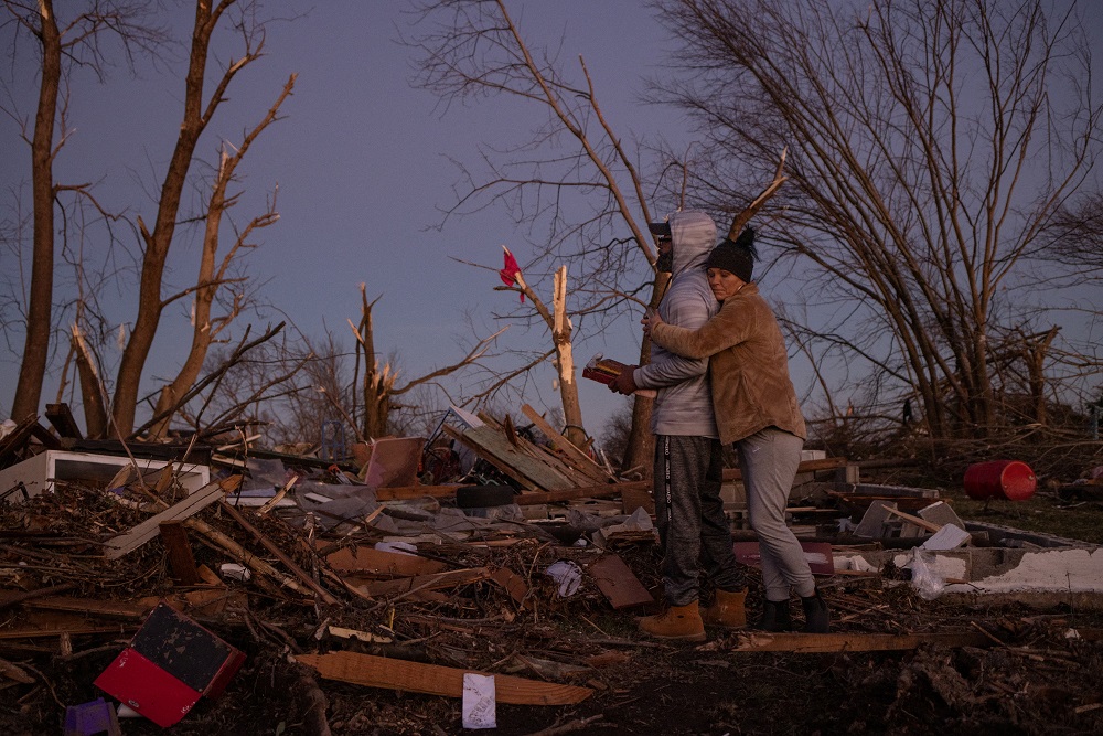 Bridget Avery embraces her friend Derrick Starks after helping him retrieve family mementos and a photo album from the destroyed home of Starksu00e2u20acu2122 uncle, in the aftermath of a tornado in Mayfield, Kentucky December 12, 2021. u00e2u20acu201d Reuters pic