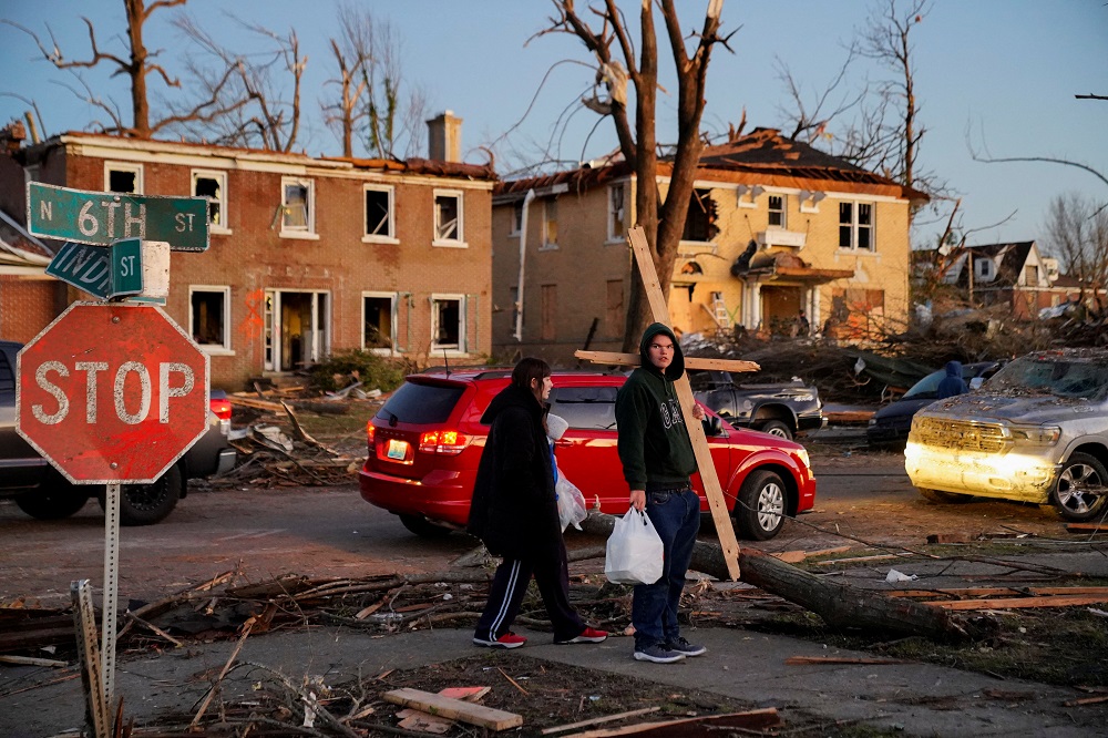 Jay Harrison, 19, carries a cross he made out of debris after a devastating outbreak of tornadoes ripped through several US states in Mayfield, Kentucky December 12, 2021. u00e2u20acu201d Reuters pic