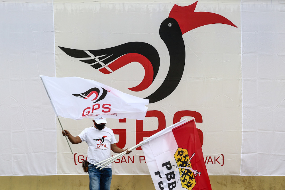 A Gabungan Parti Sarawak (GPS) campaigner putting up flags ahead of nomination day in Gedong, Sarawak December 5, 2021. u00e2u20acu201d Picture by Yusof Mat Isa 