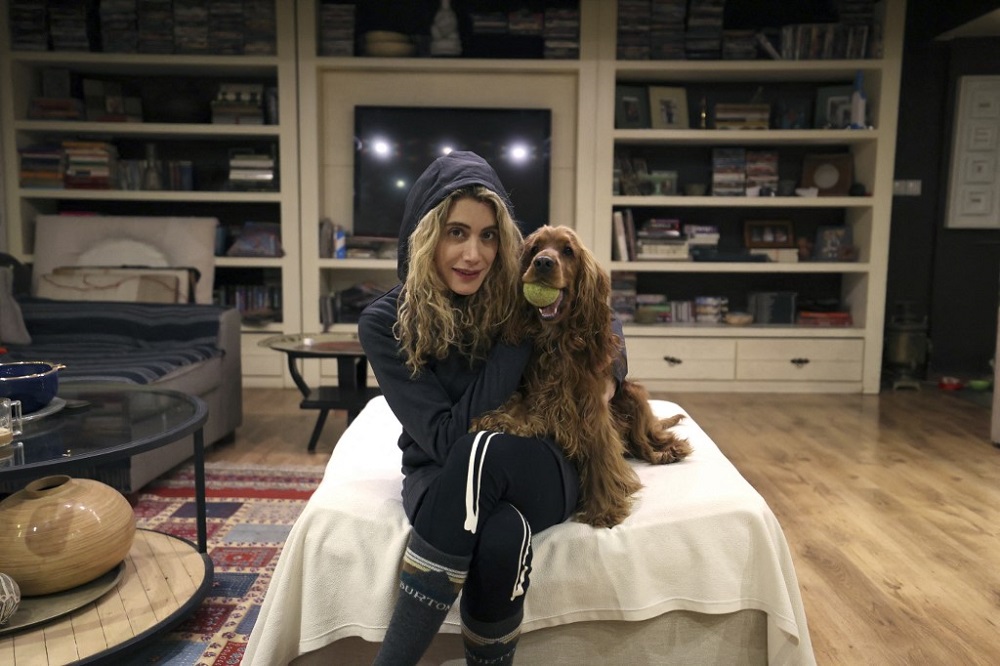 An Iranian woman poses for a picture with her dog at home in northern Tehran December 5, 2021. u00e2u20acu201d AFP pic