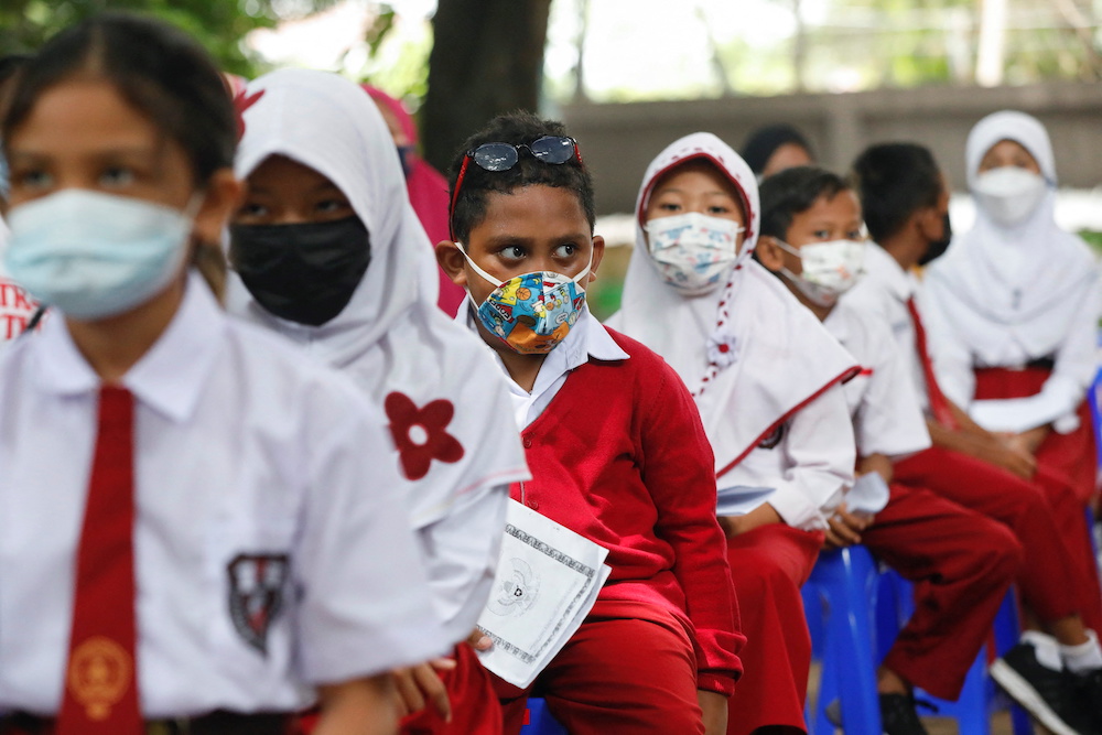 Students wait to receive their dose of the vaccine against the coronavirus disease (Covid-19), during a vaccination program for children aged 6-11 years, in Jakarta, Indonesia, December 14, 2021. u00e2u20acu201d Reuters pic