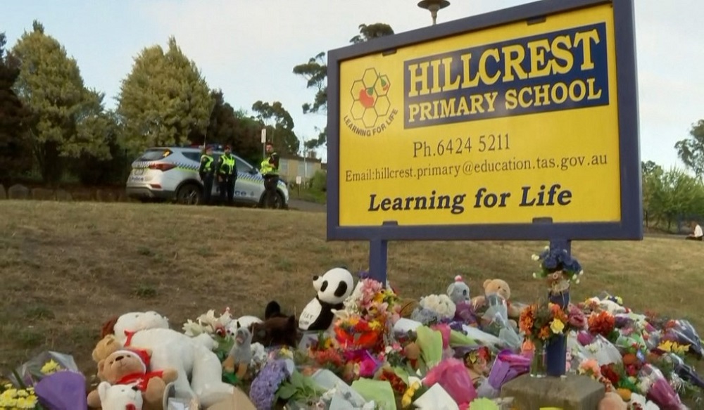 Cuddly toys and messages are left at a makeshift memorial outside the Hillcrest Primary School in the Tasmania city of Devonport, December 17, 2021. u00e2u20acu201d Screen capture taken from video released by ABC via AFPTV
