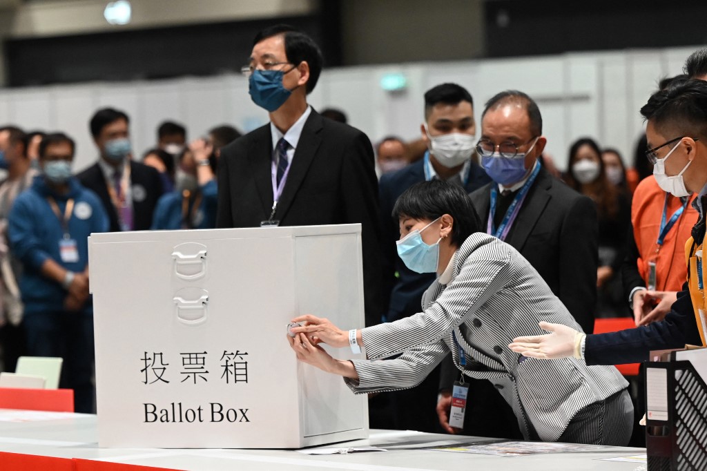 Election officials unlock the first ballot box after polls closed in the Legislative Council elections in Hong Kong on December 19, 2021. u00e2u20acu201d AFP pic