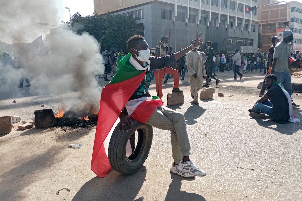 A Sudanese man gestures in a street closed by protesters during a rally in the capital Khartoum on December 19, 2021. u00e2u20acu201d AFP picnn