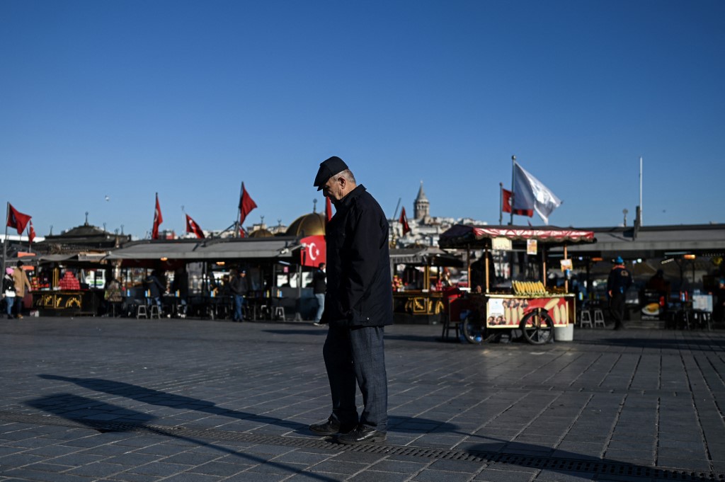 A man walks near the fish and bread vendors on December 21,2021 at Eminonu. u00e2u20acu201d AFP pic 