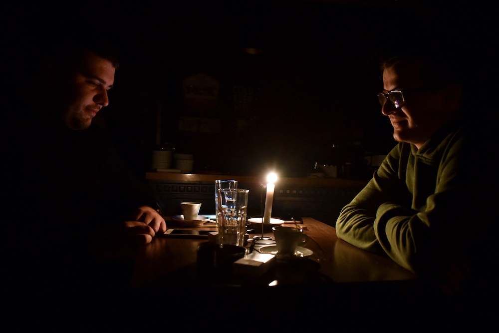 People have coffee at a bar the during the power cut in Pristina, Kosovo, December 27, 2021. Picture taken December 27, 2021. u00e2u20acu201d Reuters pic
