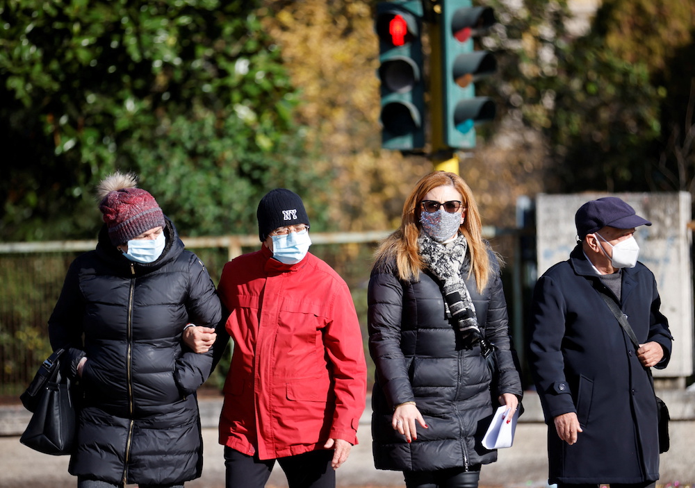 People wearing face masks walk in the street, as the region of Lazio makes face masks mandatory outdoors in all areas, as Covid-19 cases rise and Christmas nears, in Rome, Italy December 23, 2021. u00e2u20acu201d Reuters pic