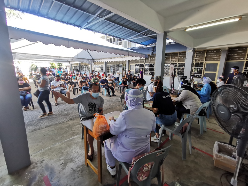 The frontliners at Tanah Puteh Health Clinic in Kuching attending to those coming for vaccination at the PPV in SJKC Chung Hua Pending, in this photo taken on July 5, 2021. u00e2u20acu201d Picture by Roystein Emmor via Borneo Post