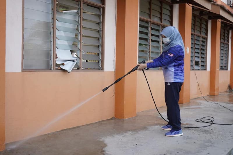 Malaysians mocked Women, Family and Community Development Minister Datuk Seri Rina Mohd Harun for seemingly hosing down already-clean drains. u00e2u20acu201d Picture courtesy of Facebook/Rina Mohd Harun
