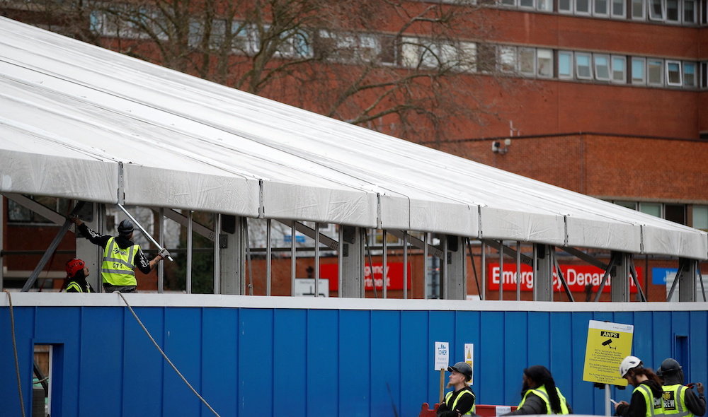 Workers construct a temporary field hospital in the grounds of St. George's Hospital, amid the spread of the Covid-19 pandemic, in London December 30, 2021. u00e2u20acu201d Reuters pic