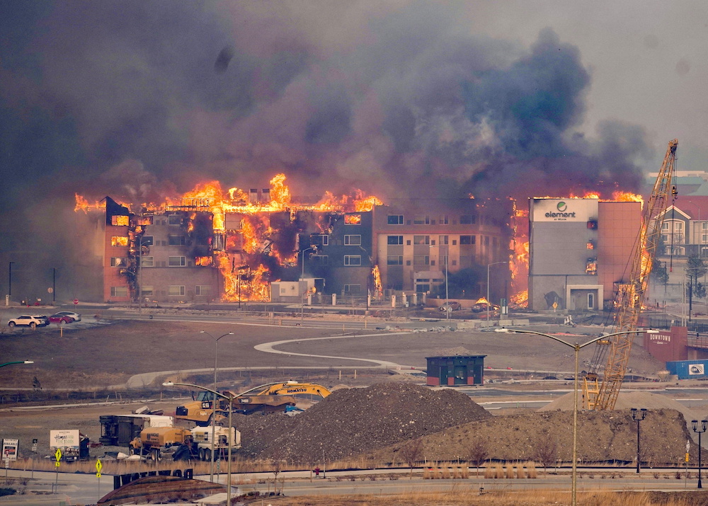 Structures burn, including an Element Hotel, as a wind-driven wildfire forced evacuation of the Superior suburb of Boulder, Colorado December 30, 2021. u00e2u20acu201d Trevor Hughes/USA Today Network via Reuters