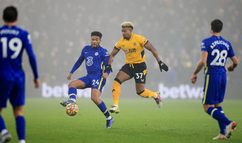 Chelseau00e2u20acu2122s English defender Reece James (2nd left) and Wolverhampton Wanderersu00e2u20acu2122 Spanish midfielder Adama Traore (2nd right) compete during the English Premier League match at the Molineux stadium in Wolverhampton, central England, December 19, 2021. u00e2u20ac