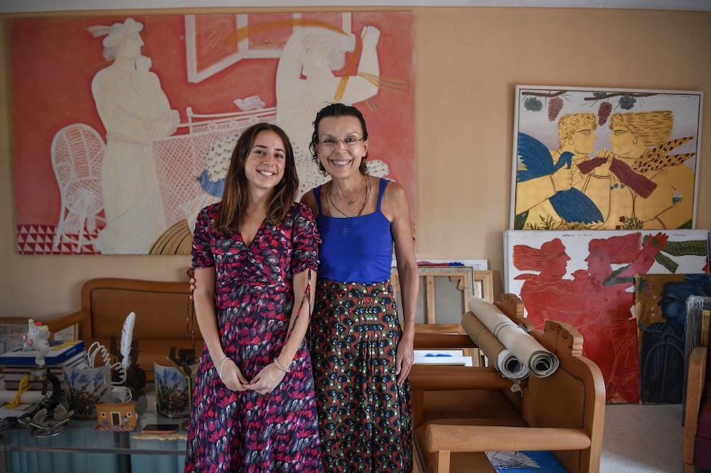 Mariza (right) and Viktoria Fassianou (left) pose next to artworks and furnitures, created by her husband and father, Greek contemporary artist Alekos Fassianos, in Athens, on September 29, 2021, prior to the opening in the fall of 2022 of a museum in his