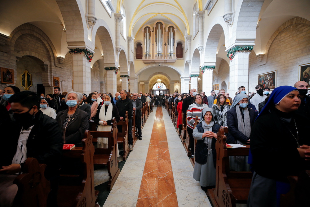 Worshipers attend Christmas morning mass at Saint Catherineu00e2u20acu2122s Church, in the Church of the Nativity, in Bethlehem in the Israeli-occupied West Bank, December 25, 2021. u00e2u20acu201d Reuters picnnn