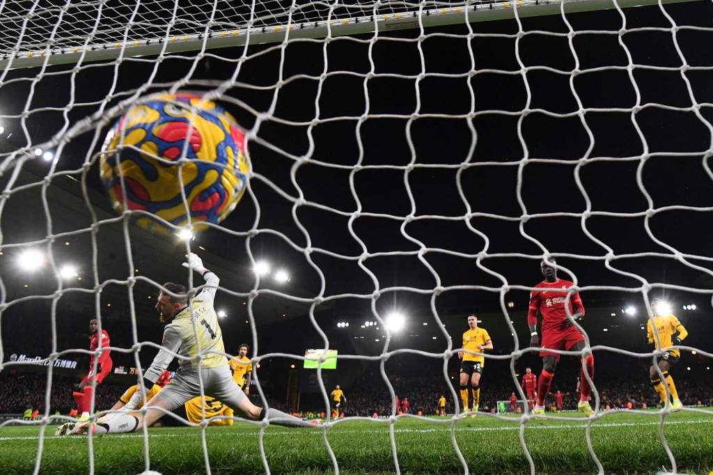 Liverpoolu00e2u20acu2122s Belgium striker Divock Origi (left) scores his teamu00e2u20acu2122s opening goal during the English Premier League match between Wolverhampton Wanderers and Liverpool at the Molineux stadium in Wolverhampton, December 4, 2021. u00e2u20acu201d AFP pic