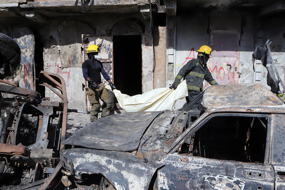 Emergency workers transport human remains found after a fuel truck exploded killing dozens of people amid reports that nearby residents had attempted to take fuel from the vehicle before it exploded, in Cap Haitien, Haiti December 15, 2021. u00e2u20acu2022 Reuters pi