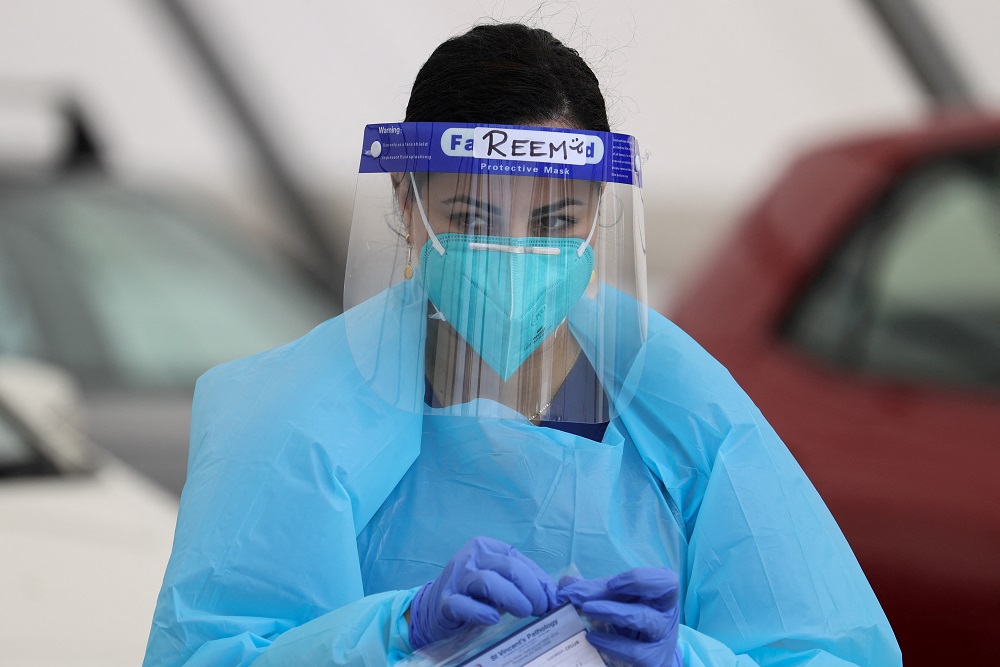 A medical worker is seen while administering tests at the Bondi Beach drive-through Covid-19 testing centre in Sydney, Australia December 22, 2020. u00e2u20acu2022 Reuters pic