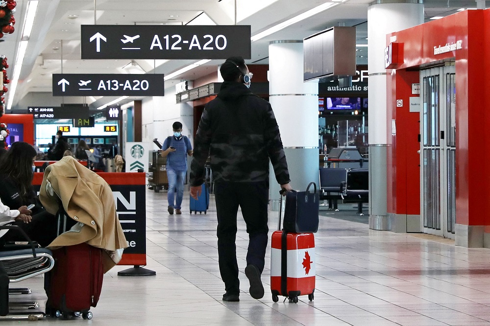 A man walks in Toronto Pearson Airport's Terminal 3 in Toronto, Ontario, Canada December 3, 2021. u00e2u20acu2022 Reuters file pic