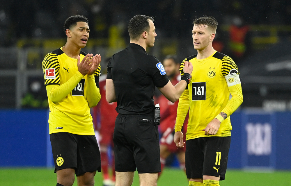 Dortmund midfielder Jude Bellingham and forward Marco Reus discuss with referee Felix Zwayer after a deliberate handball during BVB Borussia Dortmund v FC Bayern Munich match in Dortmund, western Germany, December 3, 2021. u00e2u20acu201d AFP pic 