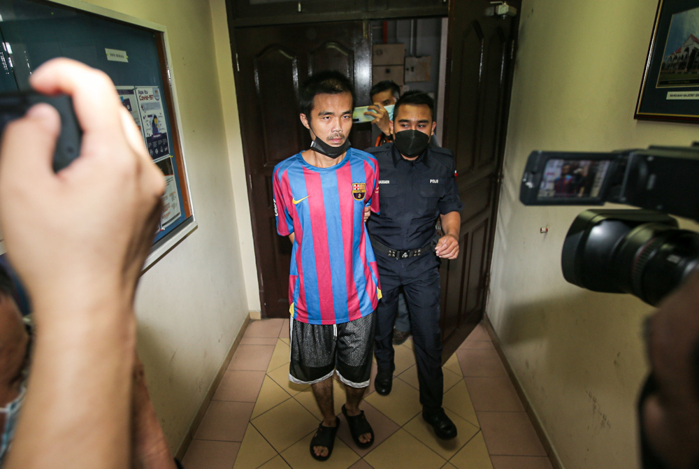 Leong Yew Chen, 35, was charged in two courts in Ipoh on charges for possession of imitation firearms, offensive weapons, police items and prohibited publications containing elements of Communist ideology, December 22, 2021. u00e2u20acu201d Picture by Farhan Najib