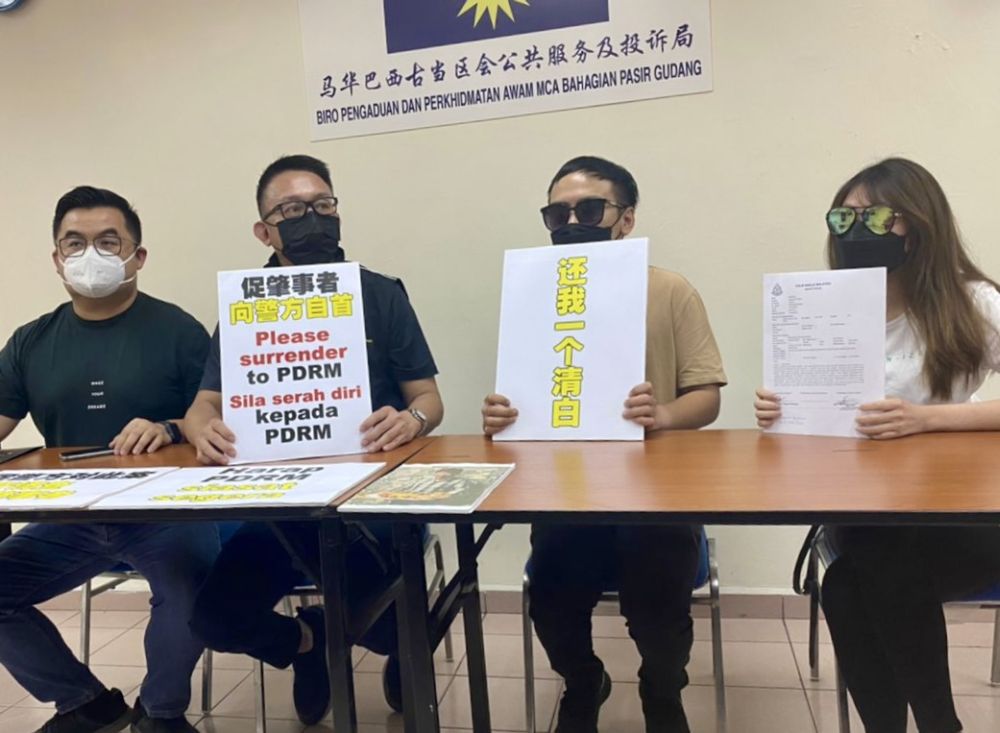 Lim (second from left) with the two victims, Benjamin Low (second from right) and Tai Yoke Eng (right) during a press conference in Johor Baru December 21, 2021. u00e2u20acu201d Picture by Ben Tannn