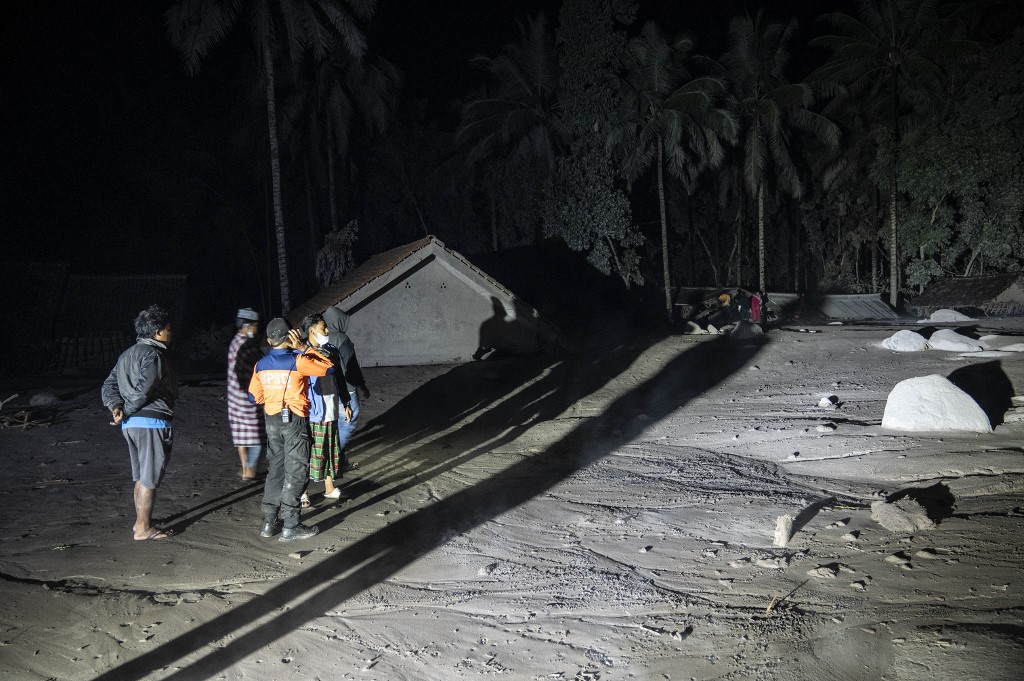 Villagers and rescuers inspect an area covered with volcanic ashes at Sumber Wuluh village, in Lumajang, on December 5, 2021, in an attempt to find survivors or bodies after the Semeru volcano eruption. u00e2u20acu201d AFP pic