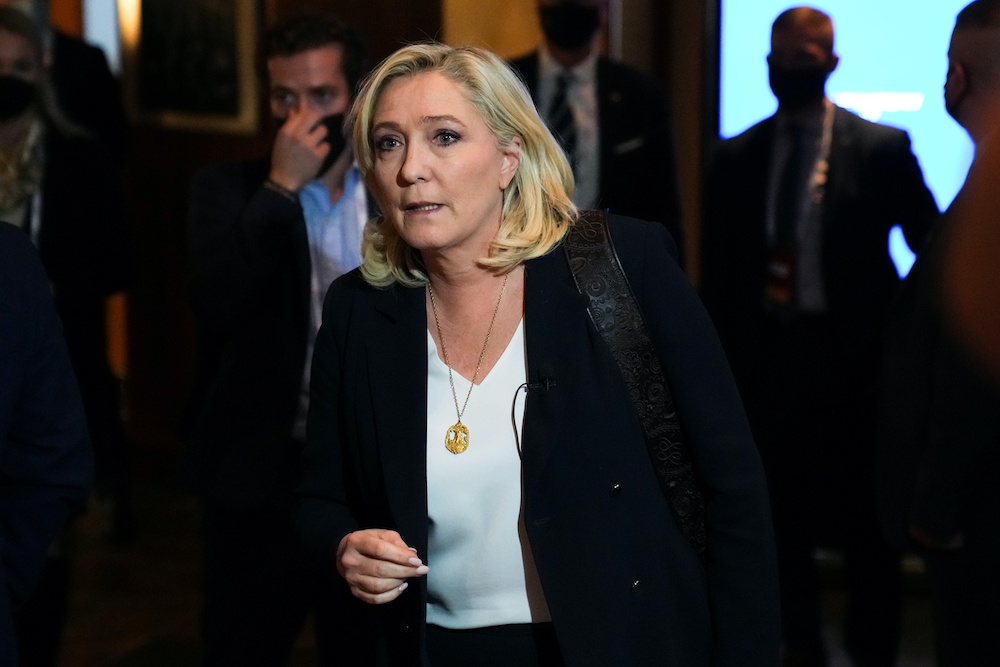 French far-right leader Marine Le Pen walks through the corridor following a meeting of Europeu00e2u20acu2122s far-right leaders, in Warsaw, Poland December 4, 2021. u00e2u20acu201d Reuters picnn